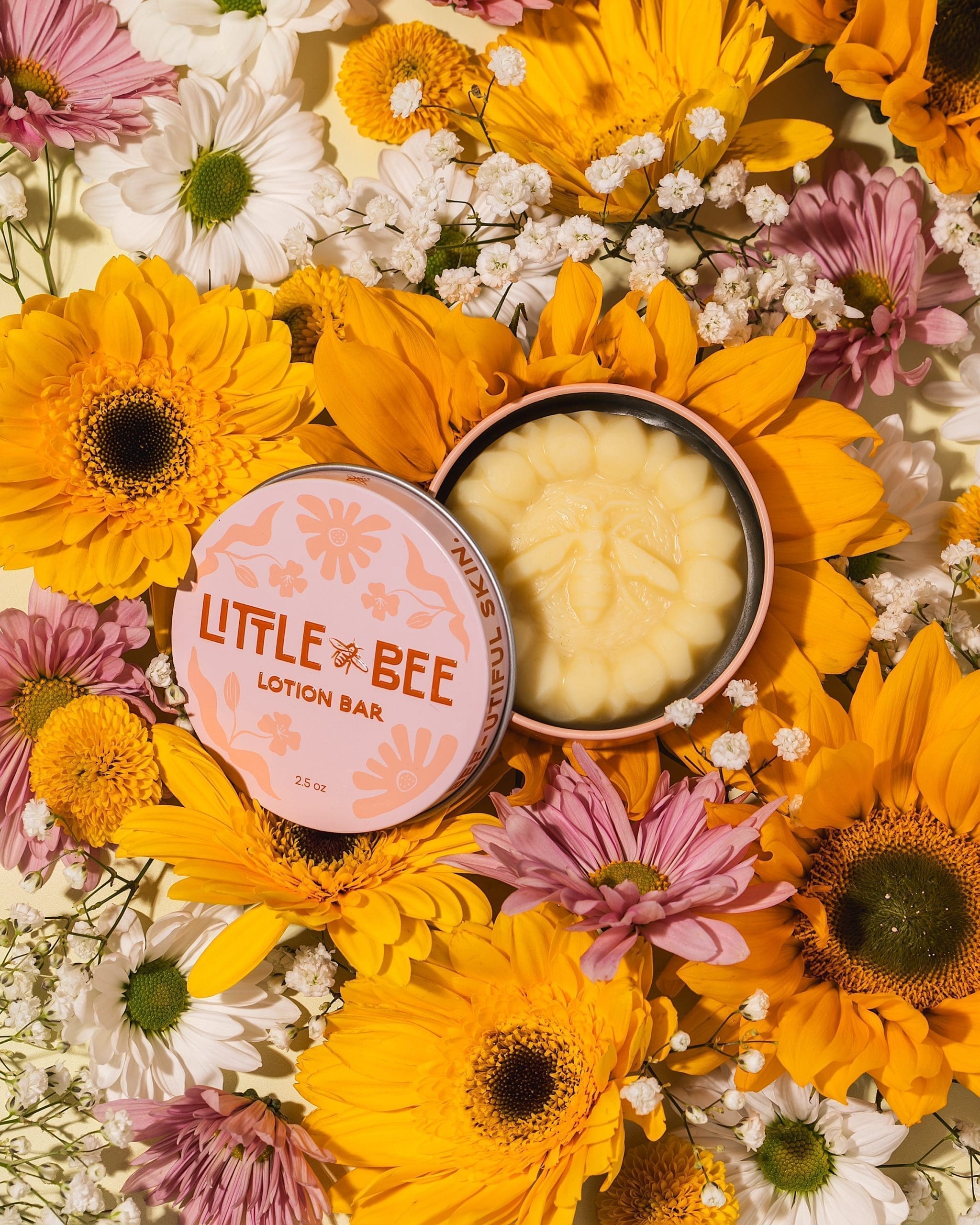 Little Bee Lotion Bar Little Bee Lotion Bar with the tin open, surrounded by fresh flowers